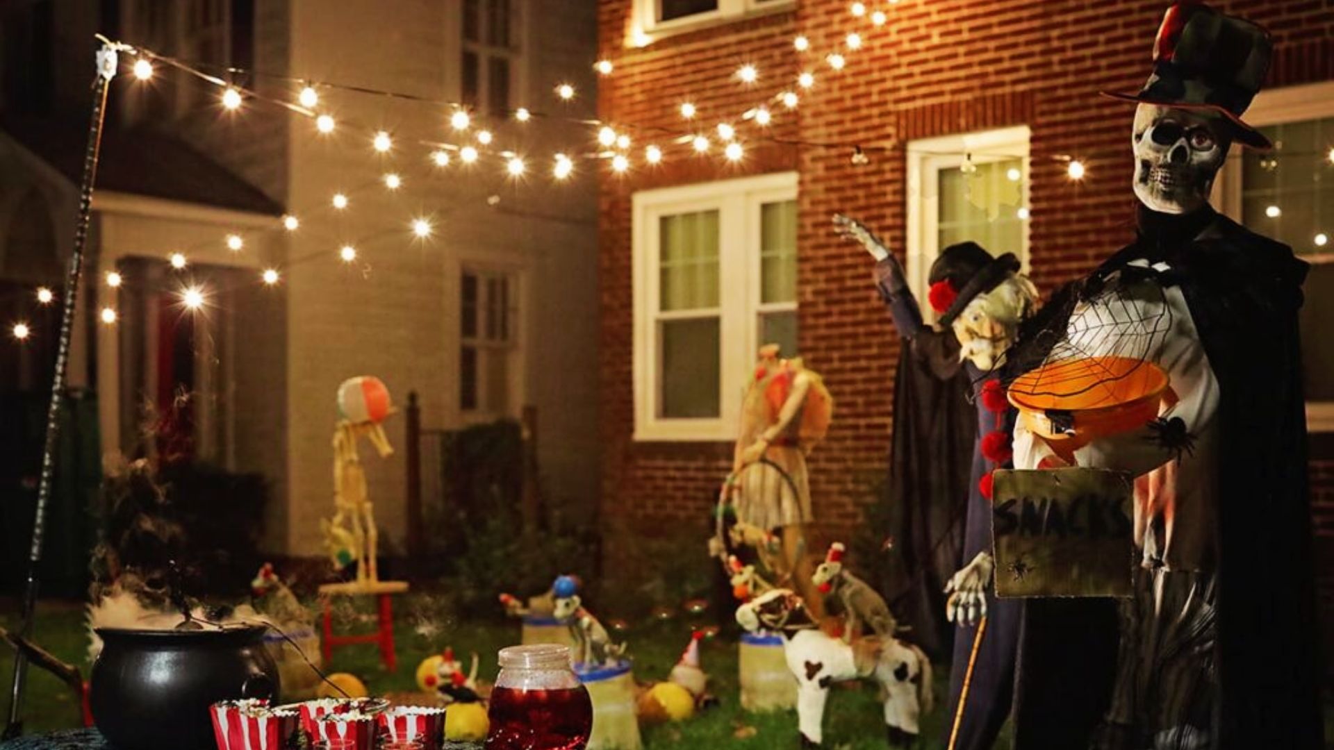 Spooky circus-themed Halloween yard display with skeletons offering snacks in Savannah.