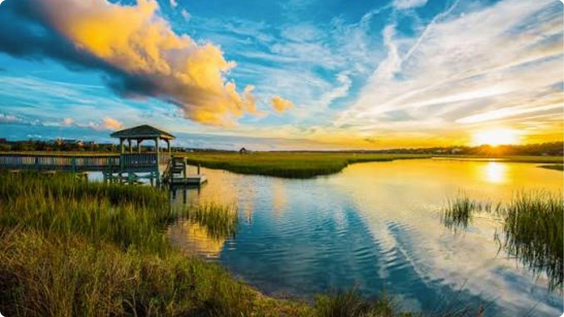 Romantic sunset gazebo over tidal marsh waters with golden reflection, couples spot in Myrtle Beach