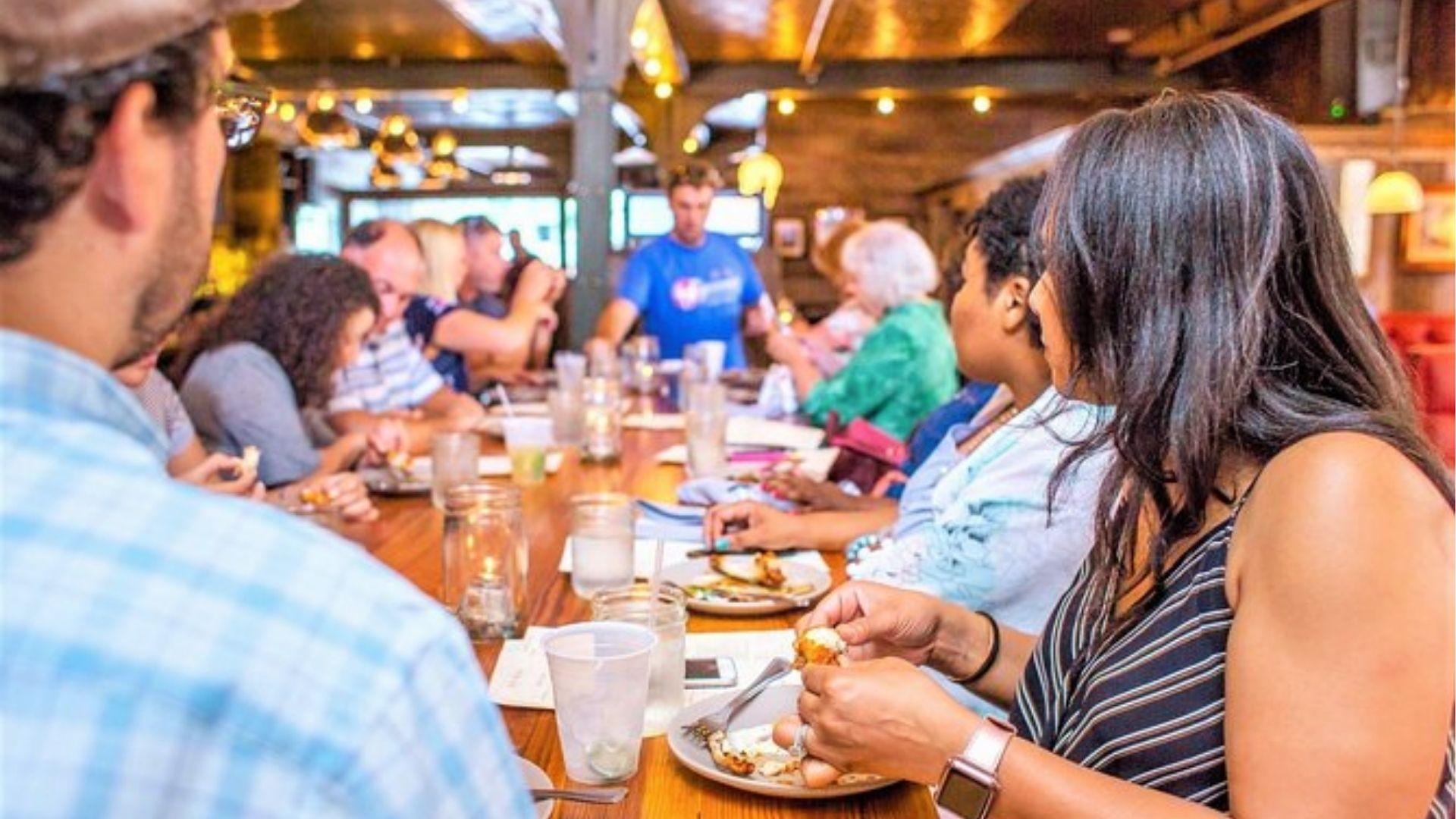 Group enjoying Savannah food tour tasting Southern cuisine in October