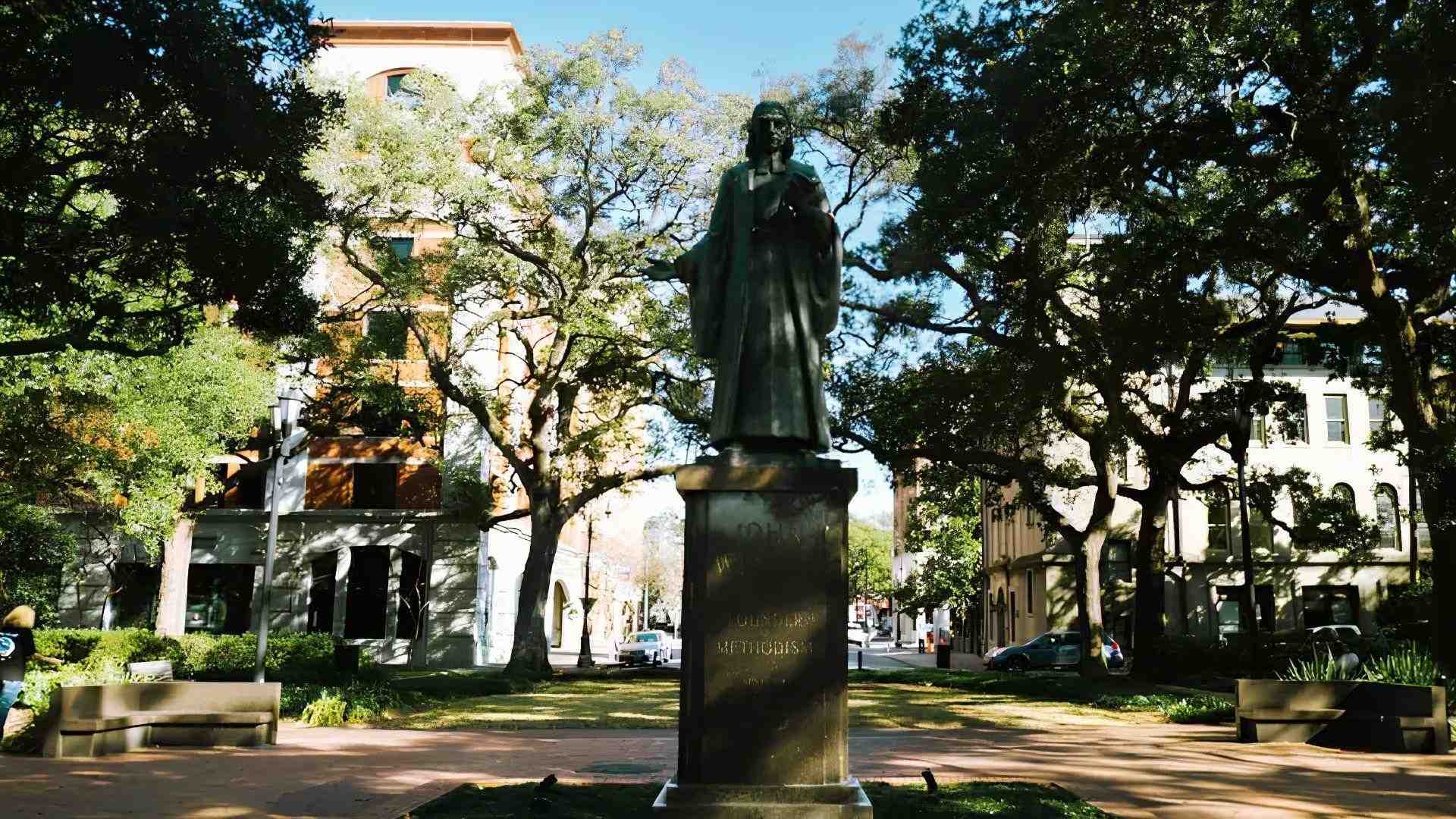 John Wesley statue in Reynolds Square surrounded by oak trees