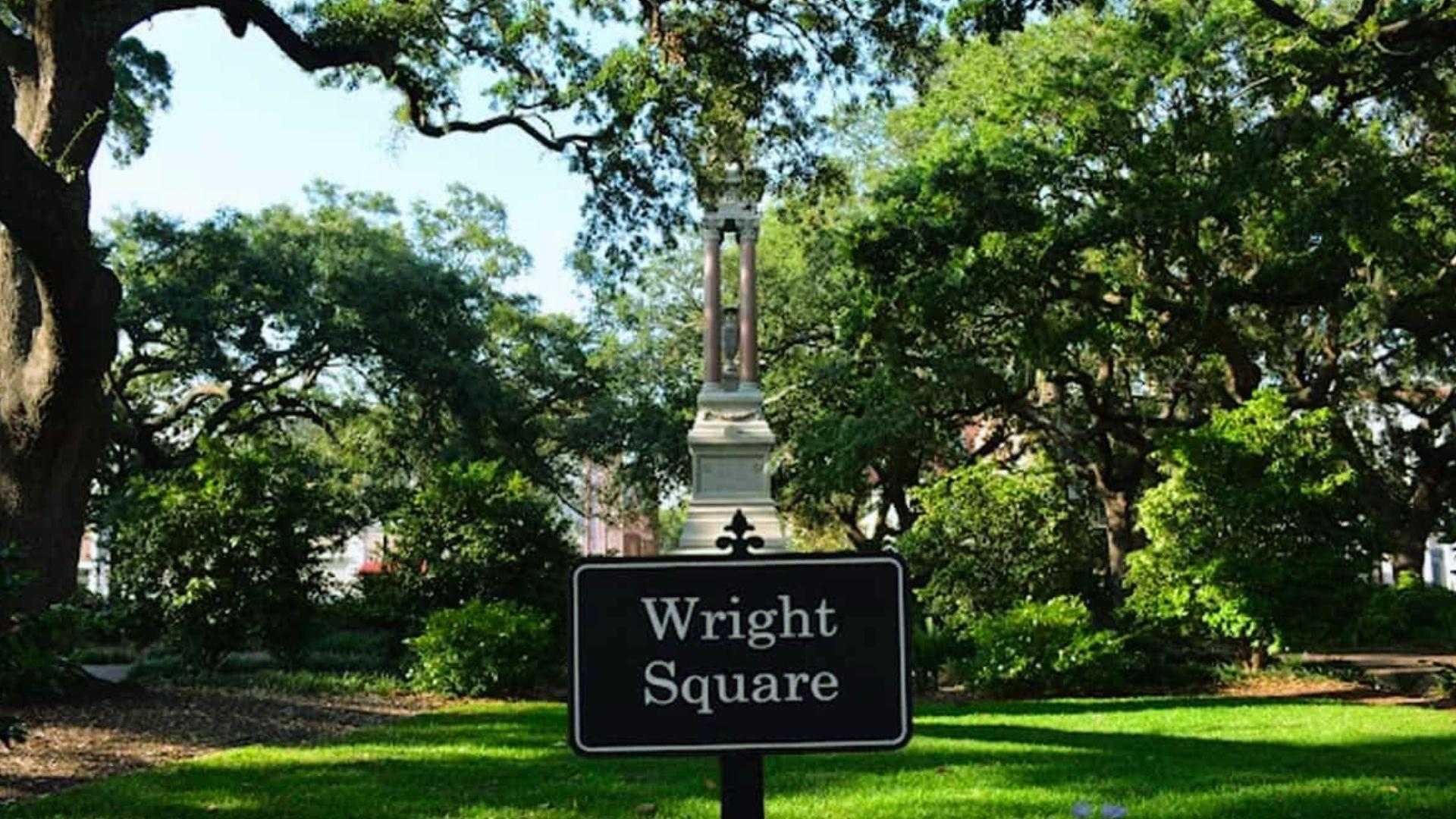 Historic Wright Square surrounded by trees and buildings in downtown Savannah