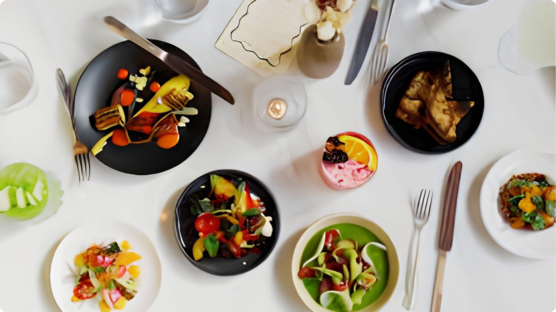 Artfully plated tasting dishes on white table for upscale happy hour experience in Savannah Georgia