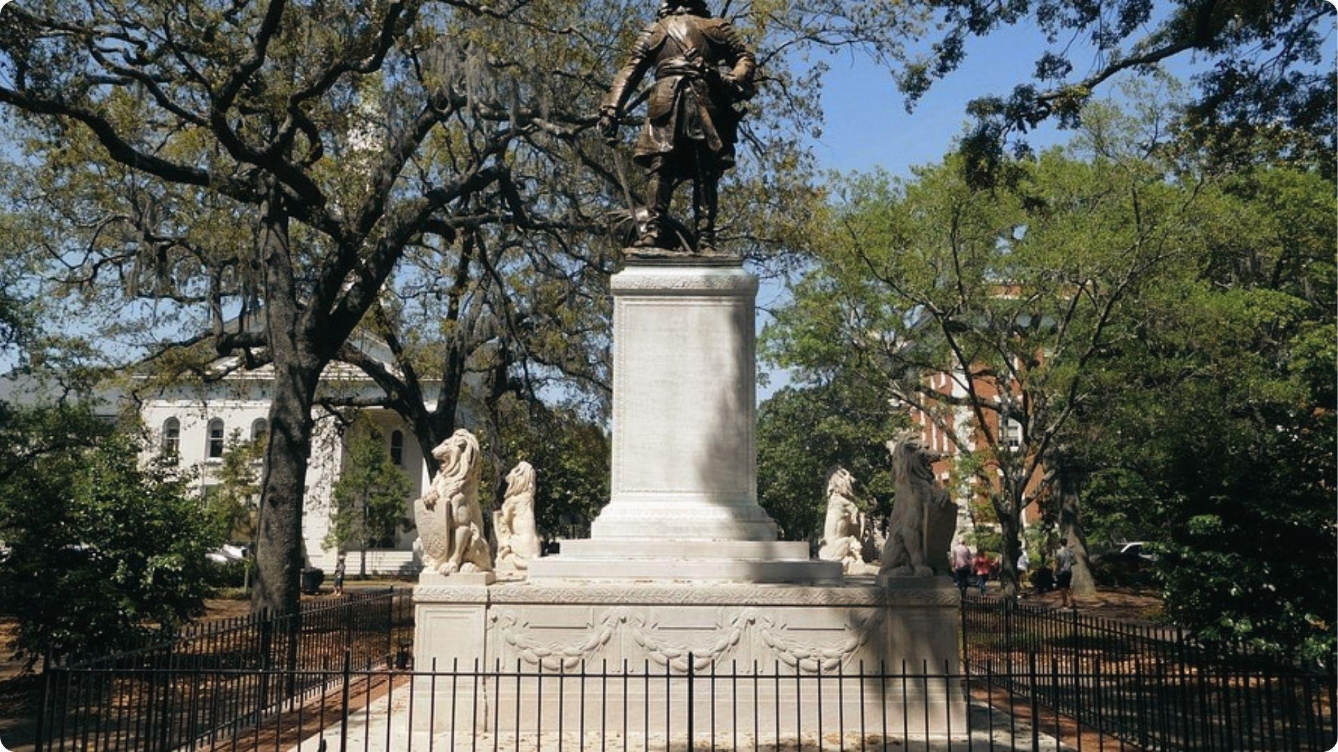 Bronze statue of James Oglethorpe with stone lions, historic monument on Savannah walking tour map