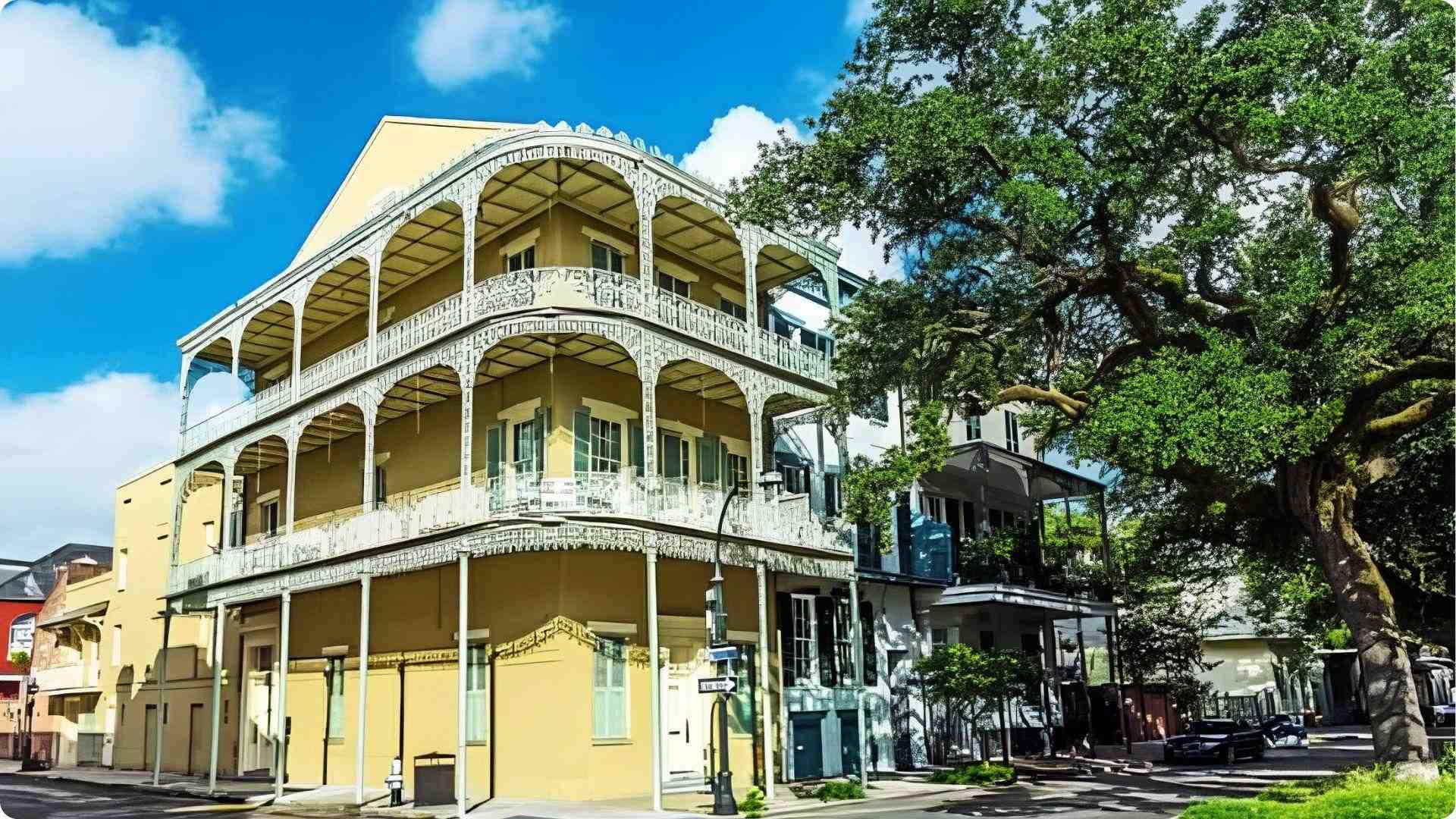 Historic yellow Creole building with ornate iron balconies, top architecture walking tour in French Quarter