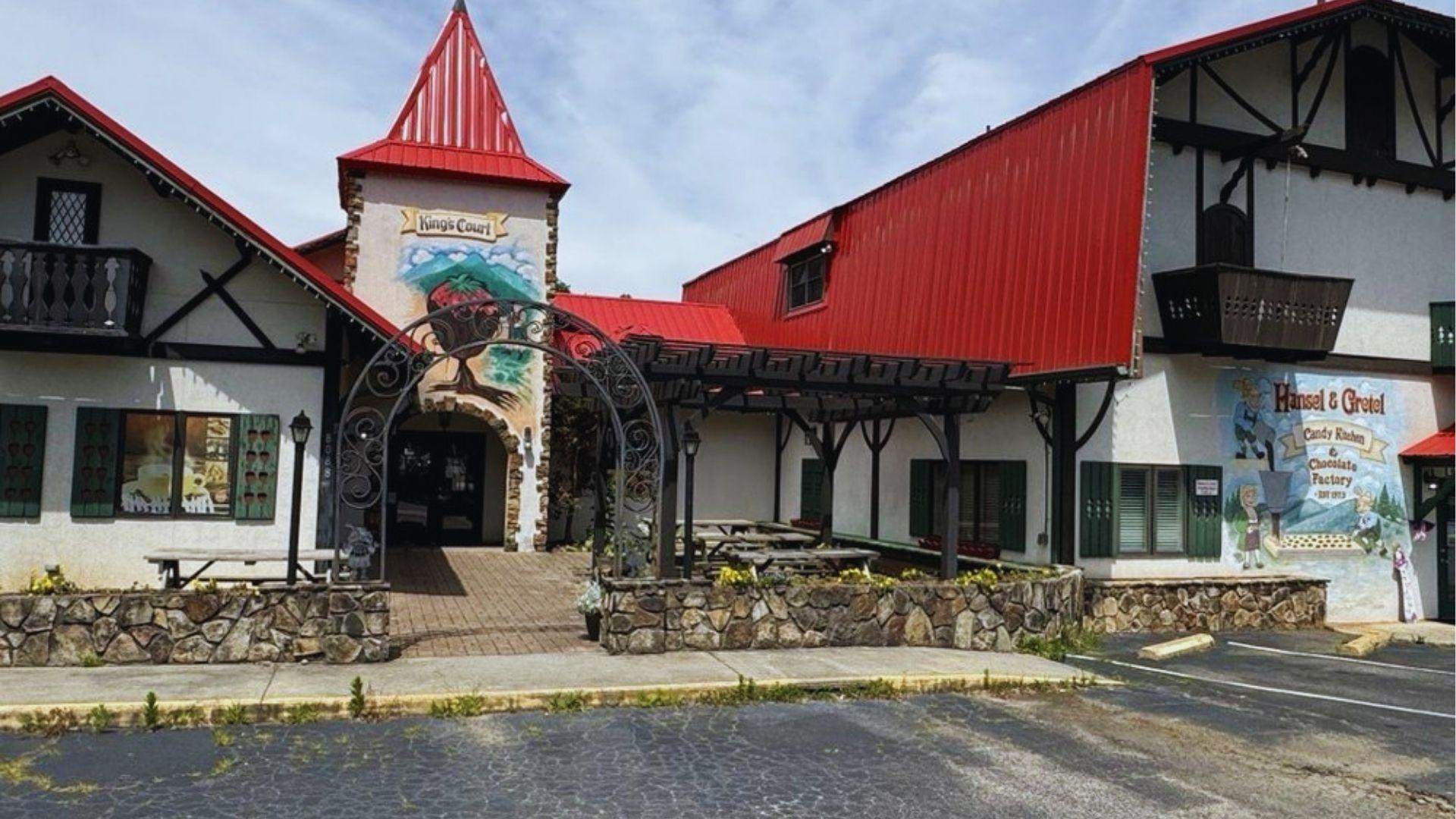 Bavarian-style building with red roof housing Hansel and Gretel candy kitchen and chocolate factory shop.