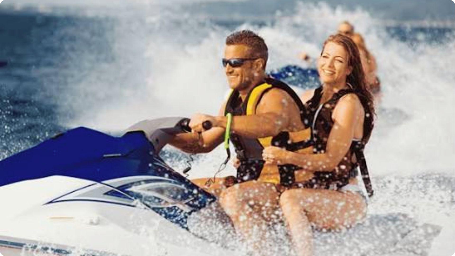 Smiling couple riding jet ski together over ocean waves, fun water activity for couples Myrtle Beach