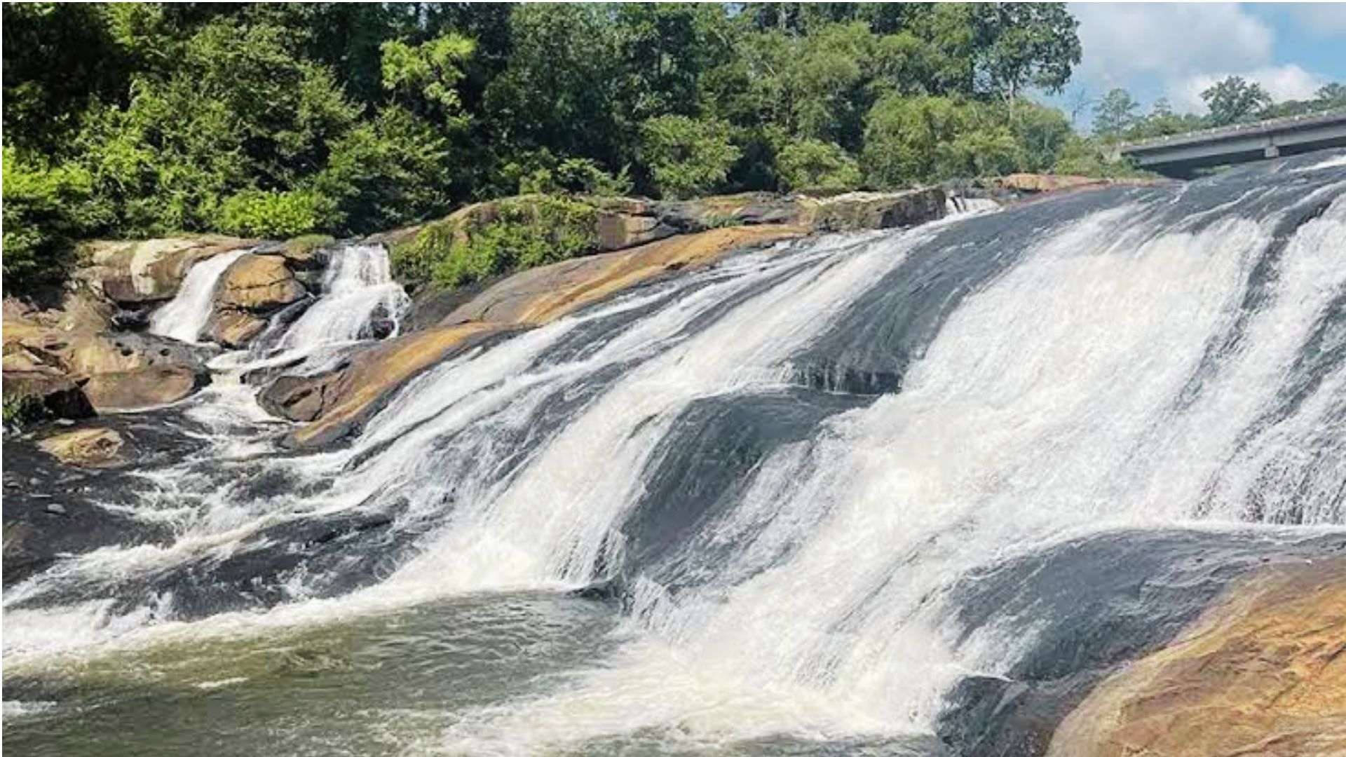 Waterfall flowing over rocky ledges at High Falls State Park in Georgia