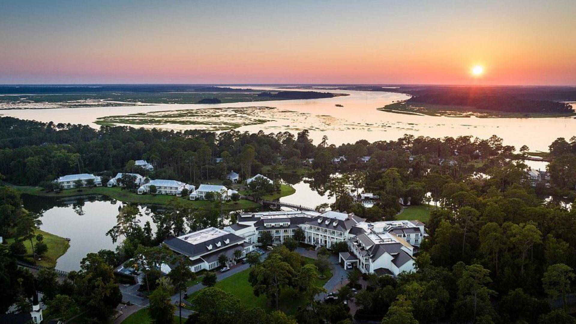 Aerial view of luxury Lowcountry resort at sunset overlooking river and marsh