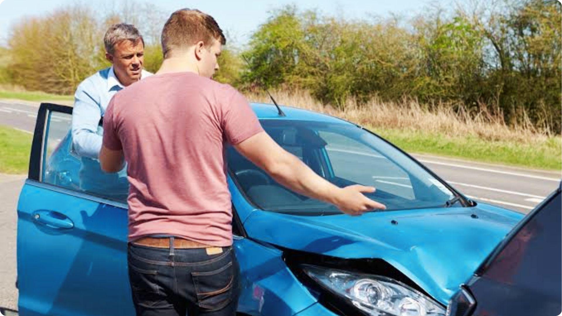 Two drivers arguing after a car crash, debating fault and liability under Georgia law.