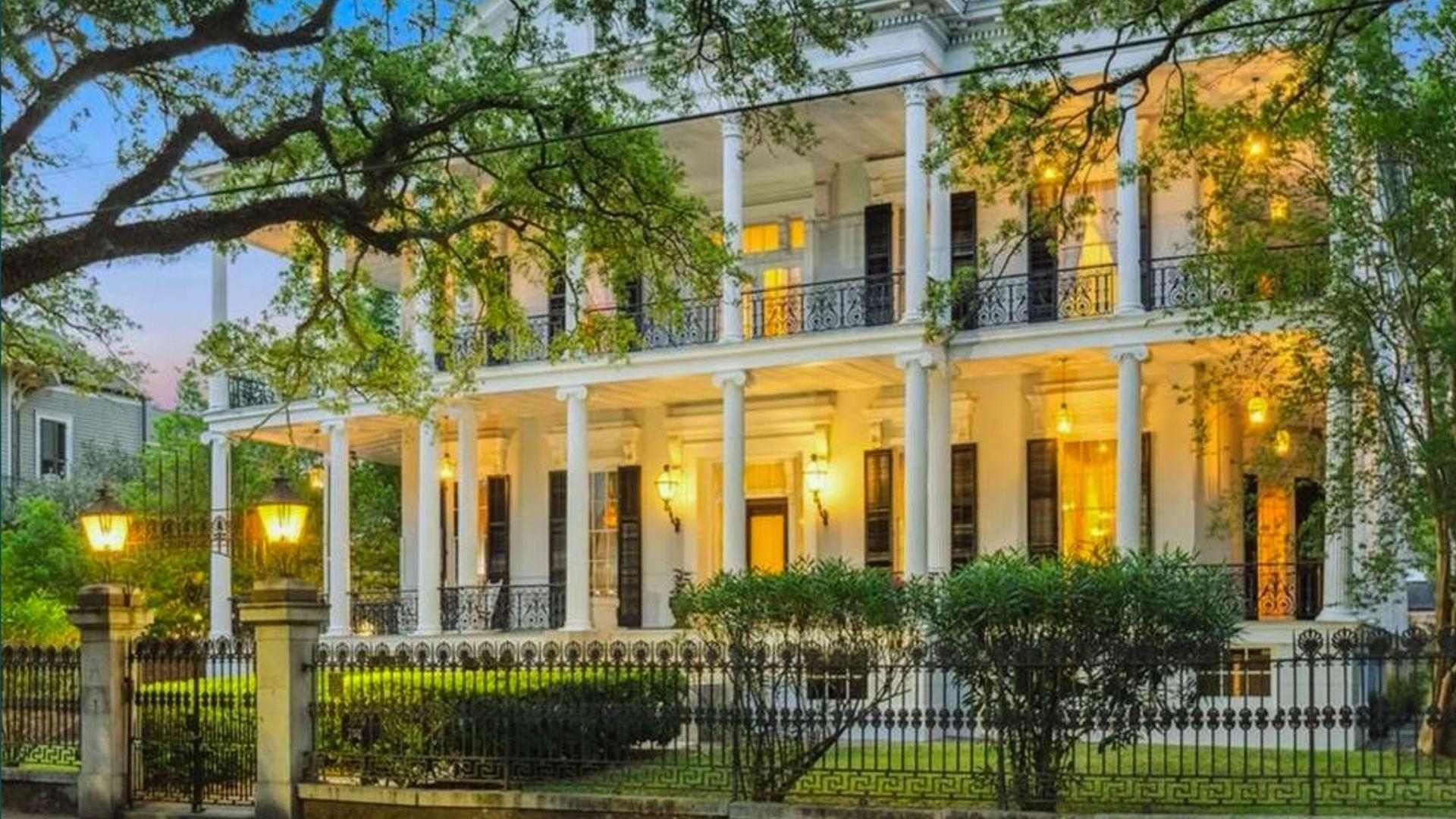 White double-gallery mansion with tall columns, palm trees, manicured lawn, inset portrait bottom left