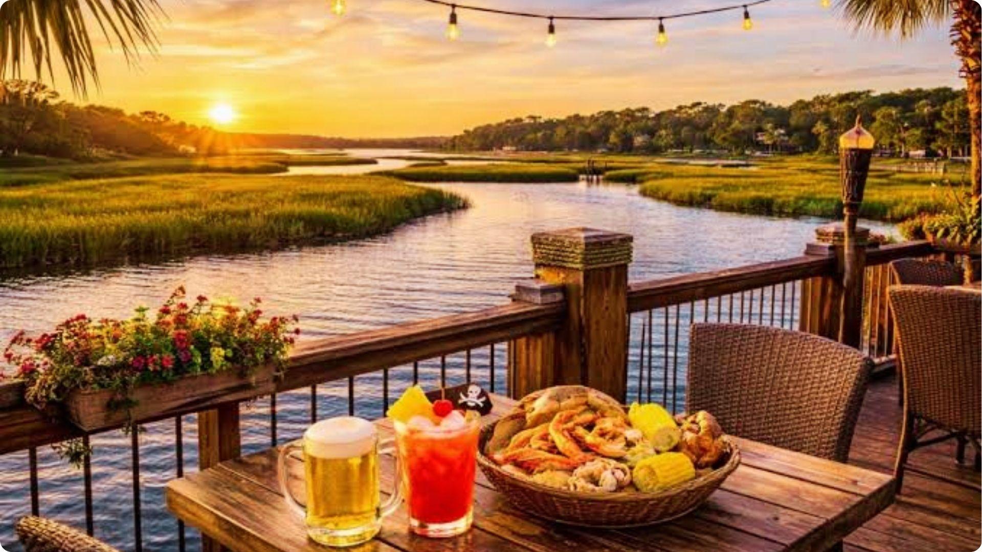 Sunset waterfront dining with seafood boil and cocktails on deck overlooking marsh Myrtle Beach