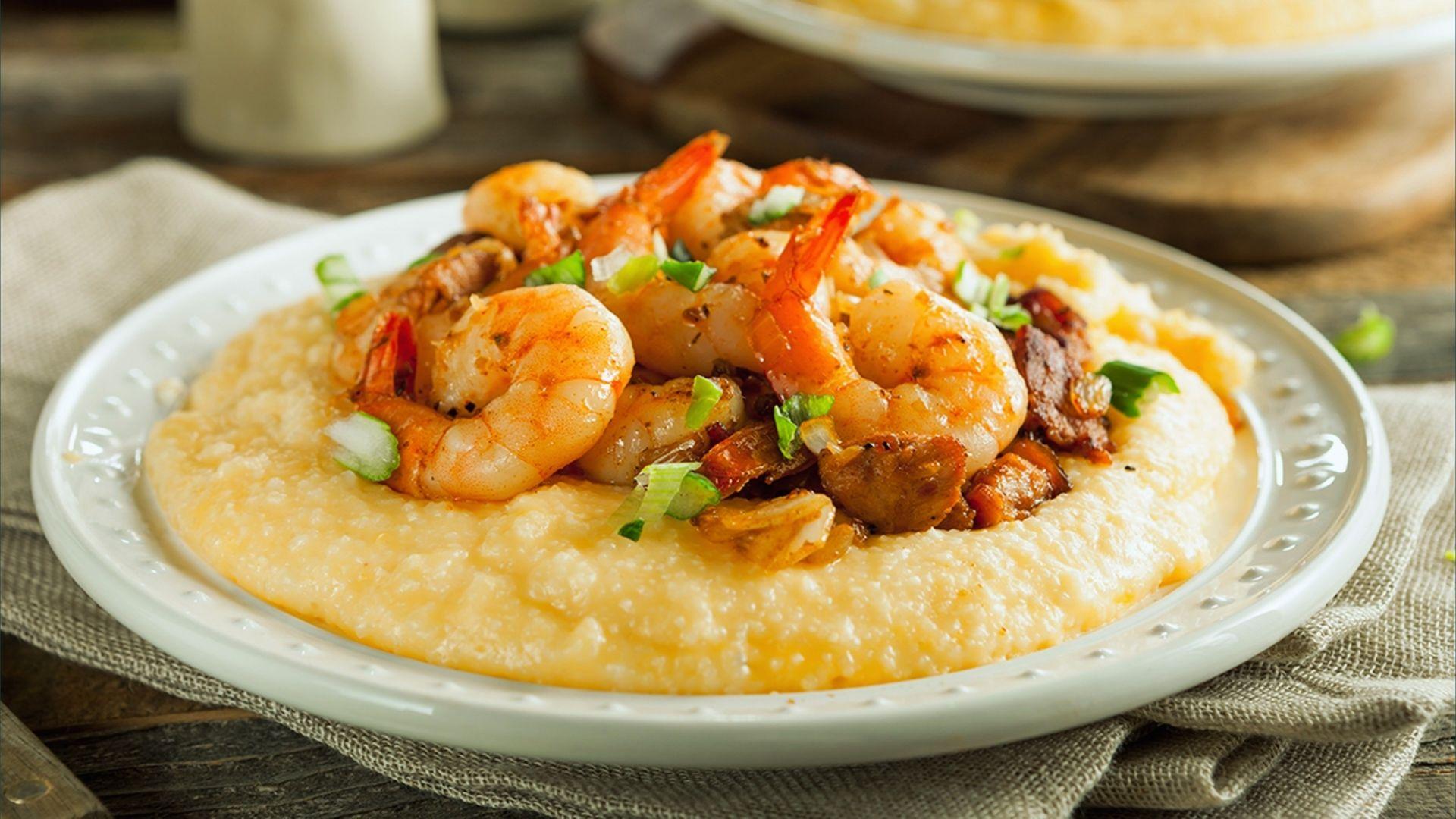 Classic shrimp and grits topped with sausage, bacon crumbles and sliced green onions