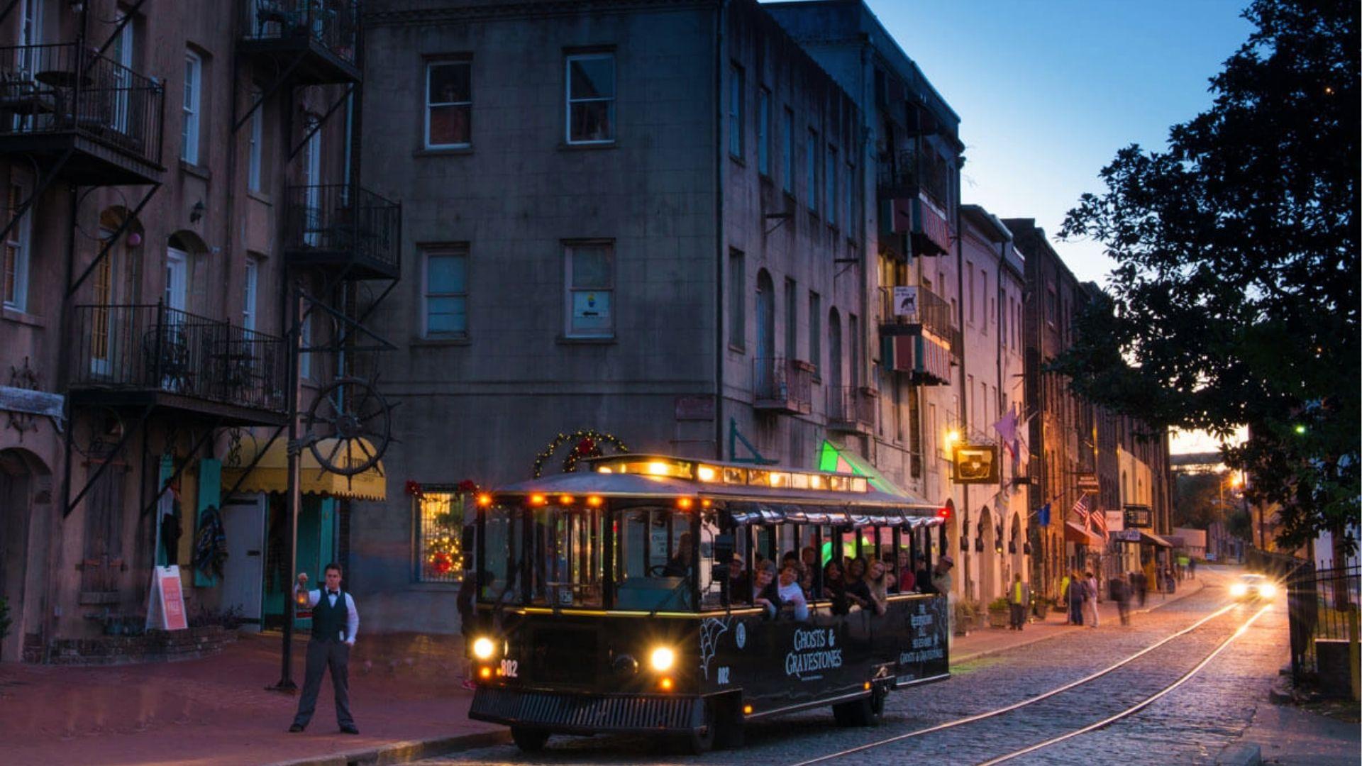 Ghosts and Gravestones trolley tour on River Street Savannah at dusk in October