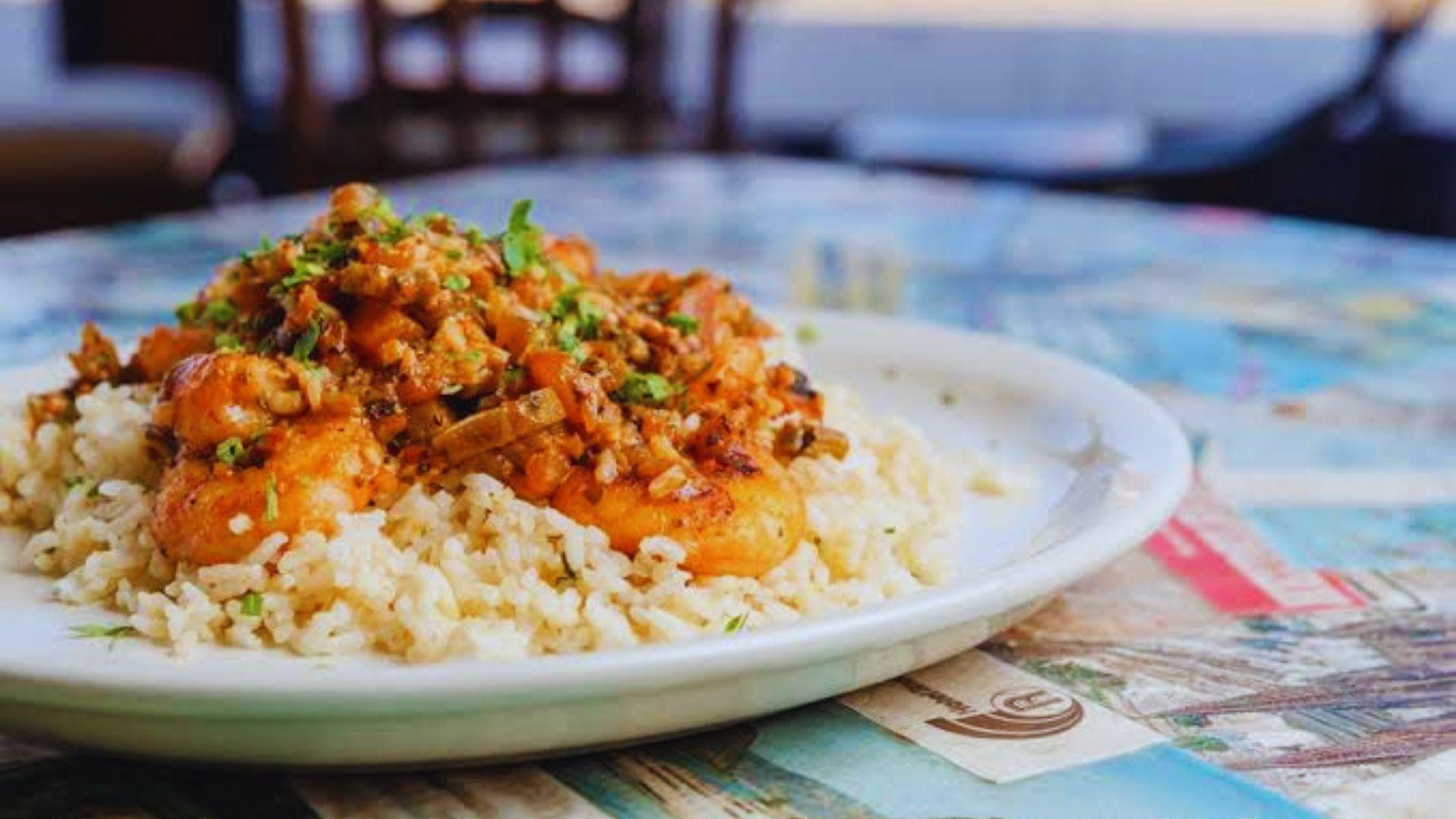 Crawfish etouffee with plump crawfish tails in a rich golden butter sauce,