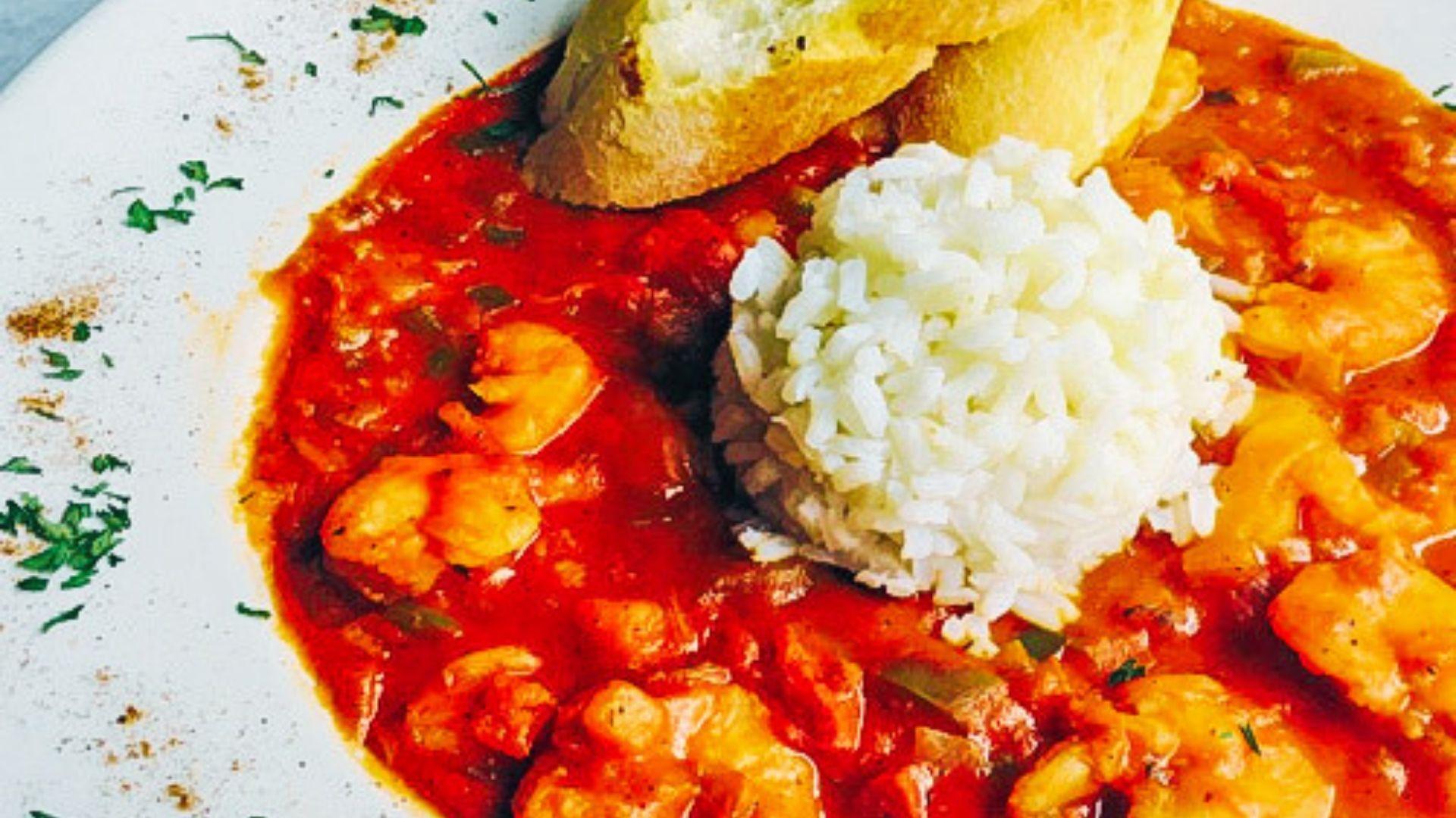 A bowl of Shrimp Creole with large Gulf shrimp in a tomato-based Creole sauce over white rice.