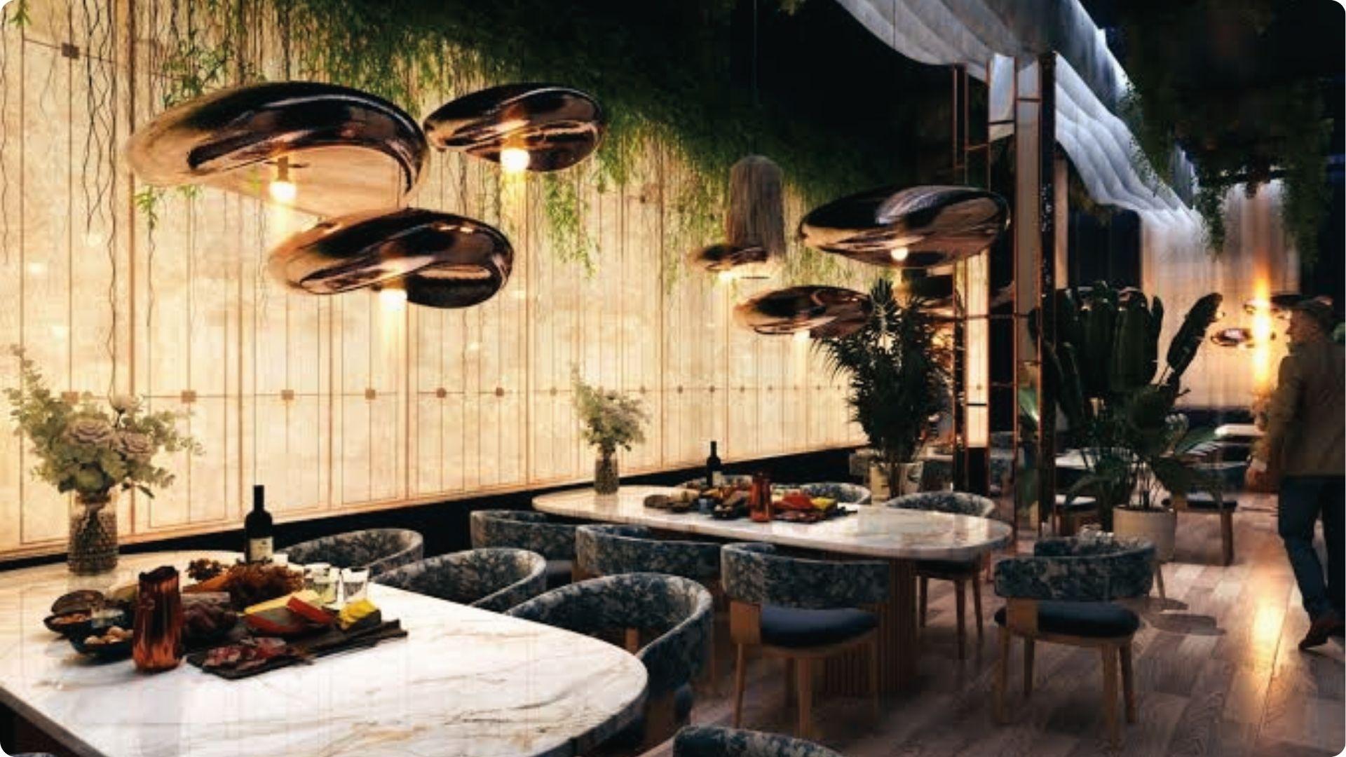Upscale Atlanta dining room with sculptural pendants, marble tables, lush greenery and floral decor