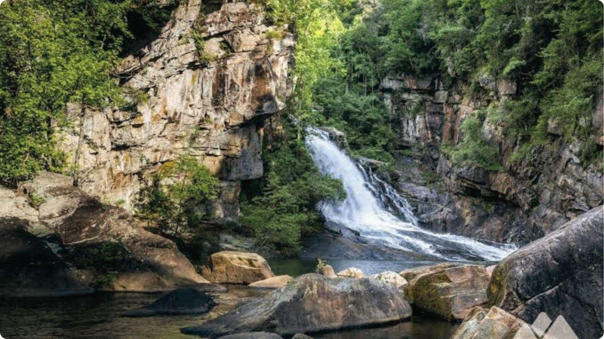 Tallulah Gorge waterfall cascading down rocky cliffs into a pool, stunning hiking day trip from Atlanta.