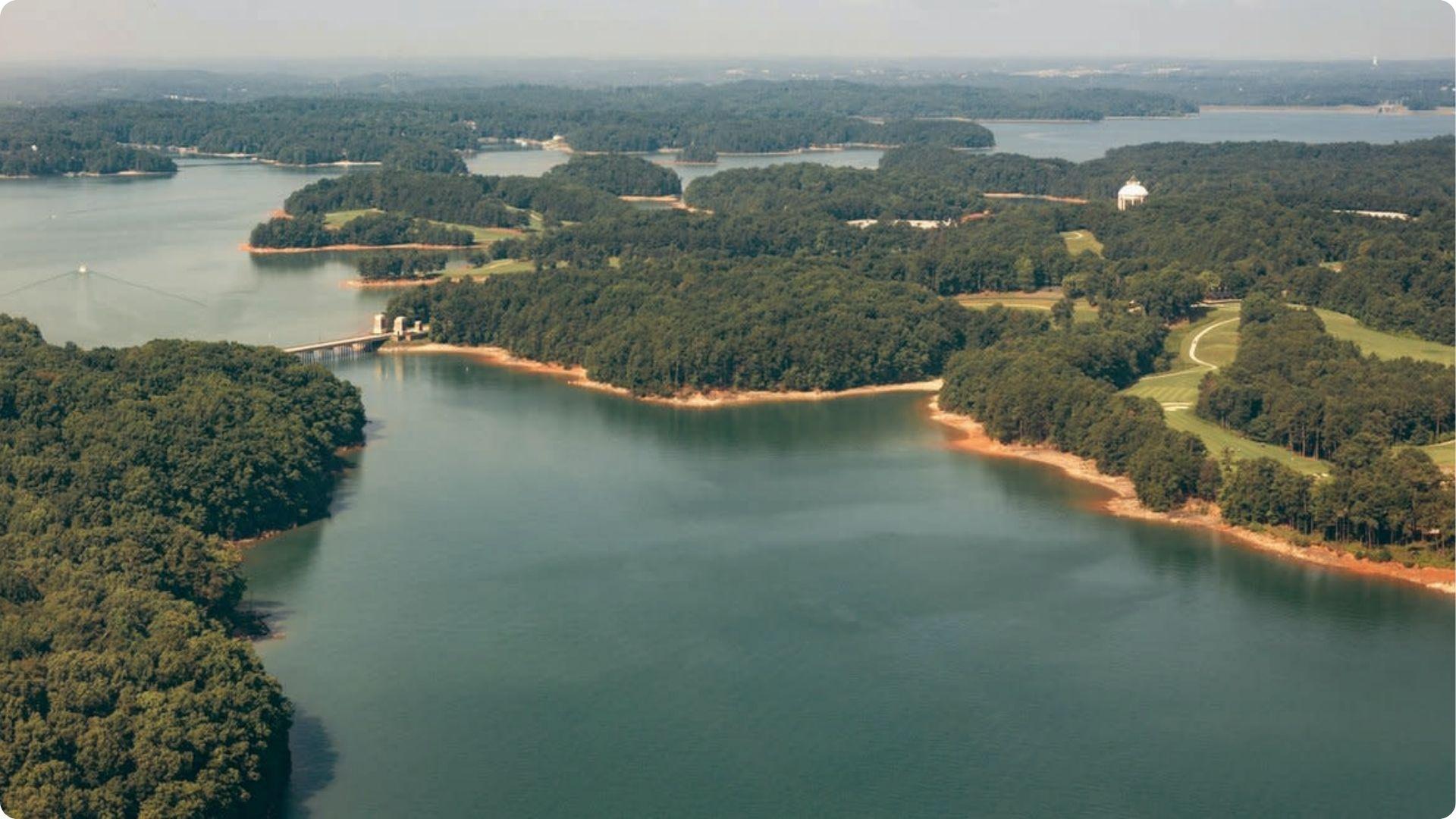 Aerial view of Lake Lanier with islands and green forests, scenic boating day trip from Atlanta getaway.