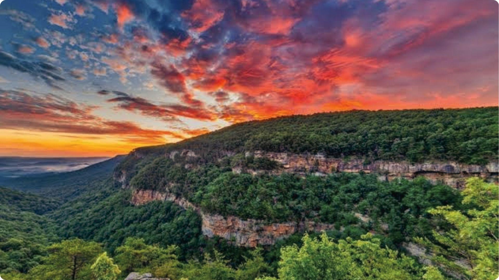 Cloudland Canyon sunset with fiery red clouds over rocky cliffs, breathtaking day trip from Atlanta.