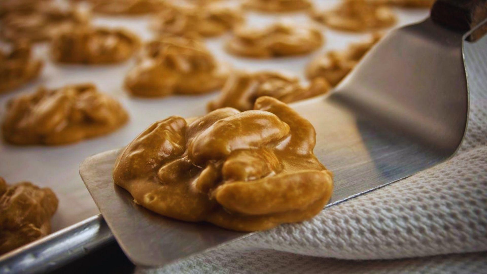 New Orleans pecan pralines on parchment paper, golden brown and studded with toasted pecans.