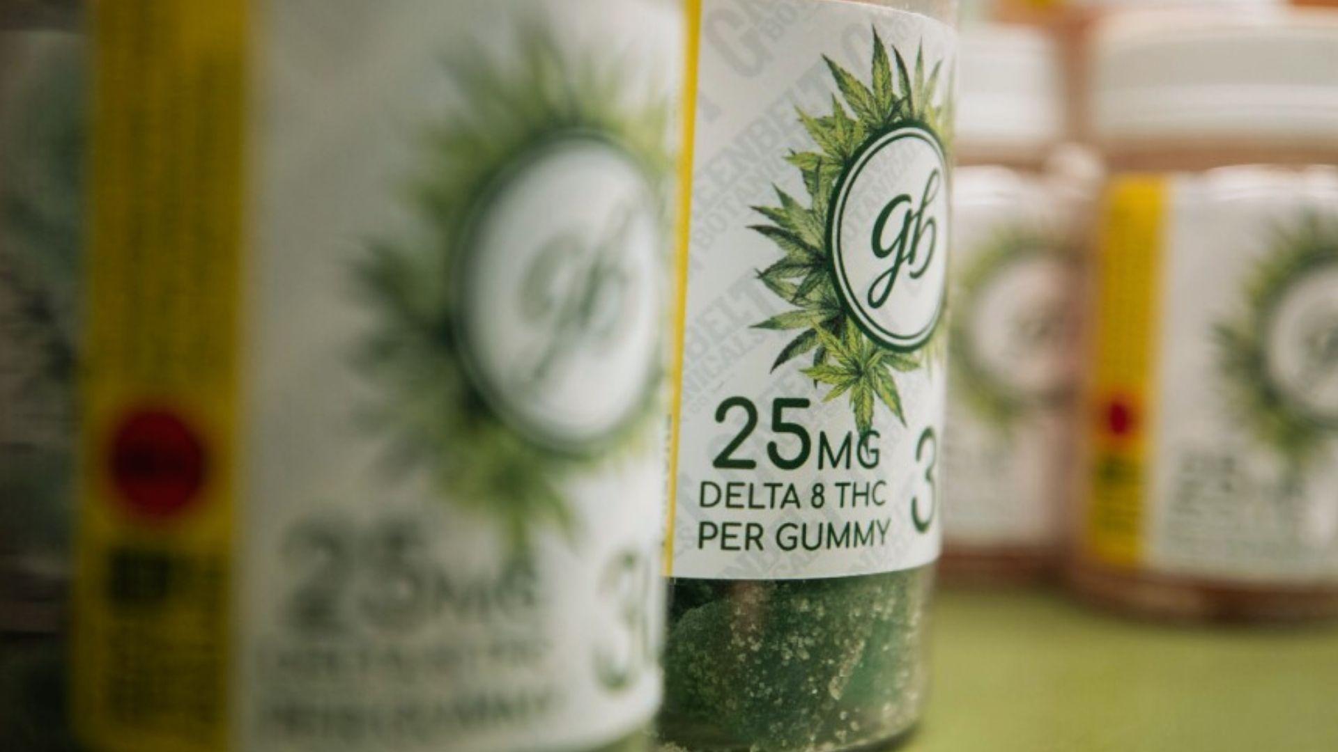 Close-up of jars labeled 25MG Delta 8 THC per gummy with cannabis leaf logo