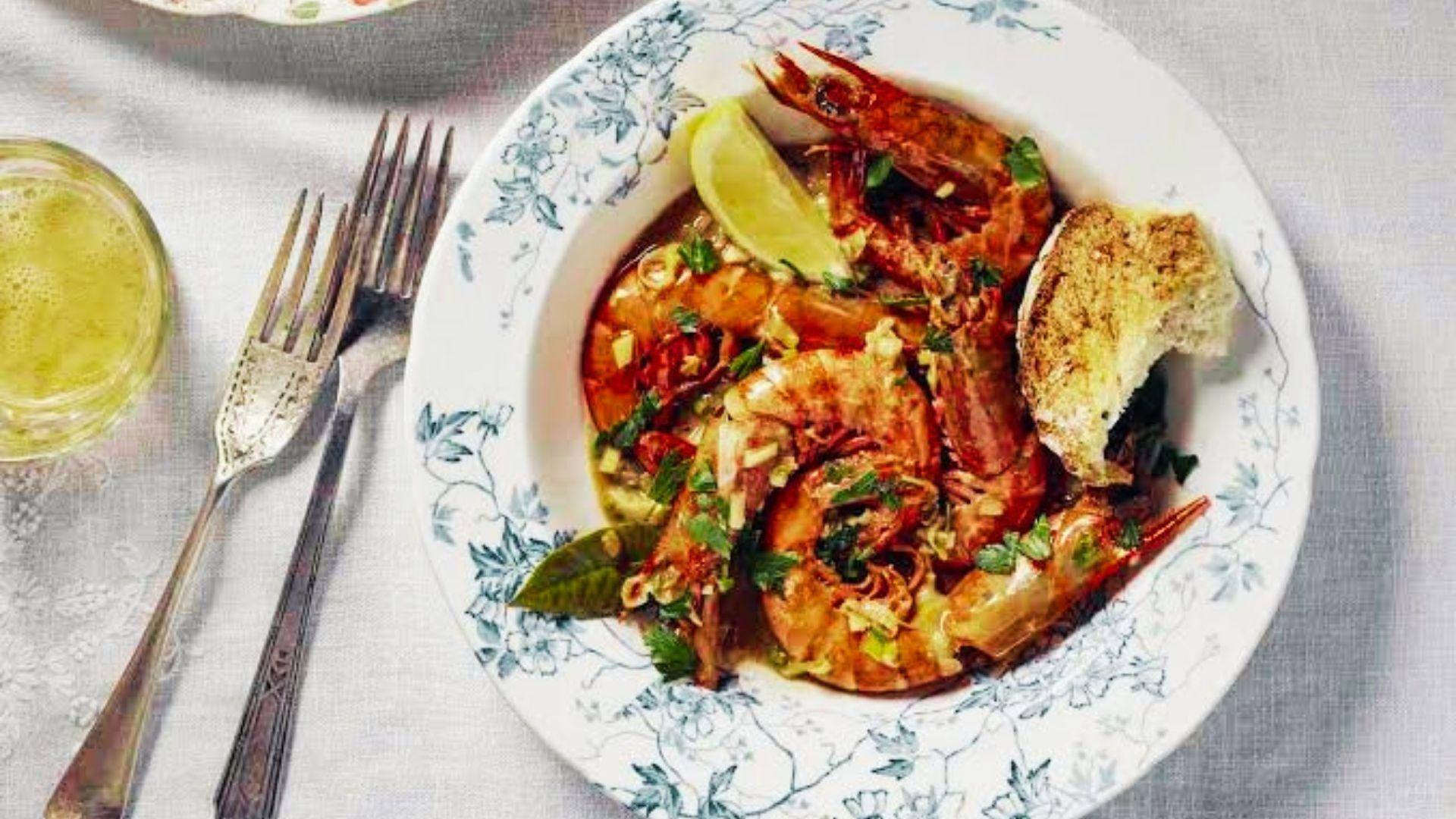 barbecue shrimp in the shell, swimming in a peppery butter sauce, with French bread on the side.